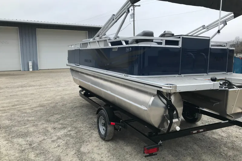 Slide: The Image of 2026 Avalon 19 Venture Quad Fish pontoon boat on trailer, parked outdoors. - 4