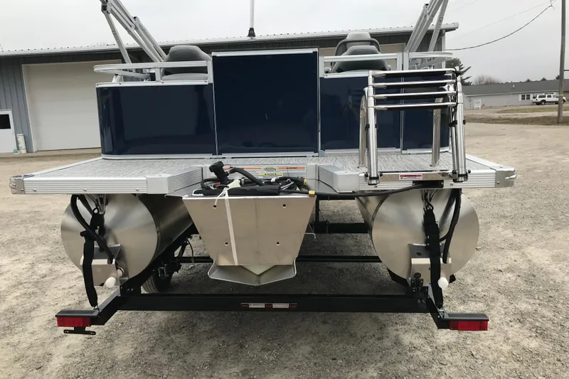 Slide: The Image of 2026 Avalon 19 Venture Quad Fish pontoon boat, rear view with ladder and dual pontoons. - 6