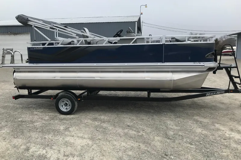 Slide: The Image of 2026 Avalon 19 Venture Quad Fish pontoon boat on trailer, side view. - 8