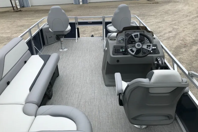 Slide: The Image of 2026 Avalon 19 Venture Quad Fish pontoon boat interior with seating and steering console. - 9