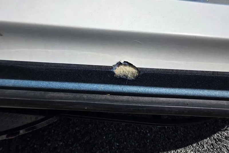 Slide: The Image of Damaged hull of 2008 Nitro 482 DC boat showing fiberglass exposure. - 10