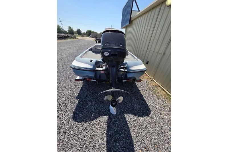 Slide: The Image of 2008 Nitro 482 DC boat rear view, parked on gravel beside a metal building. - 19