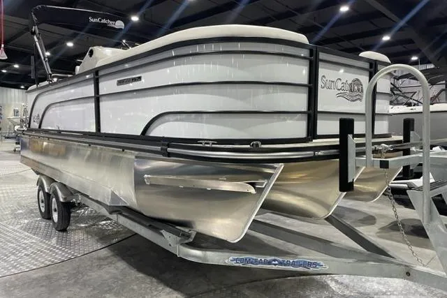 Slide: The Image of 2024 SunCatcher Select 322RC pontoon boat on trailer in showroom. - 0