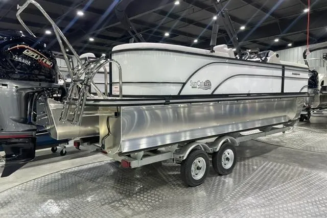 Slide: The Image of 2024 SunCatcher Select 322RC pontoon boat on trailer in showroom. - 1