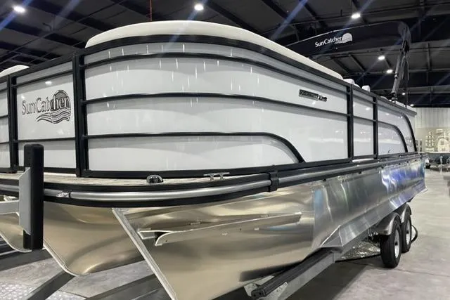 Slide: The Image of 2024 SunCatcher Select 322RC pontoon boat in showroom, showcasing sleek design and modern features. - 3