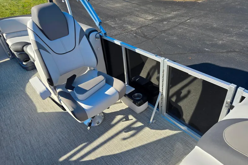 Slide: The Image of 2023 Avalon LSZ Quad Lounger boat seat with armrest and cup holder, on a sunny day. - 13