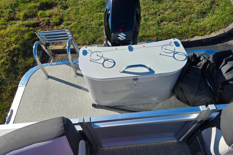 Slide: The Image of 2023 Avalon LSZ Quad Lounger boat deck with motor and storage compartment. - 16