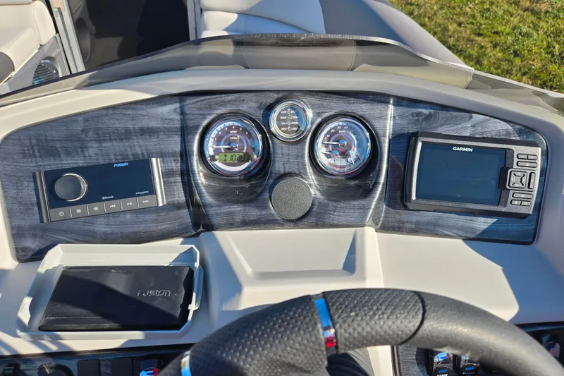 Slide: The Image of Dashboard of 2023 Avalon LSZ Quad Lounger with Garmin and Fusion systems. - 23