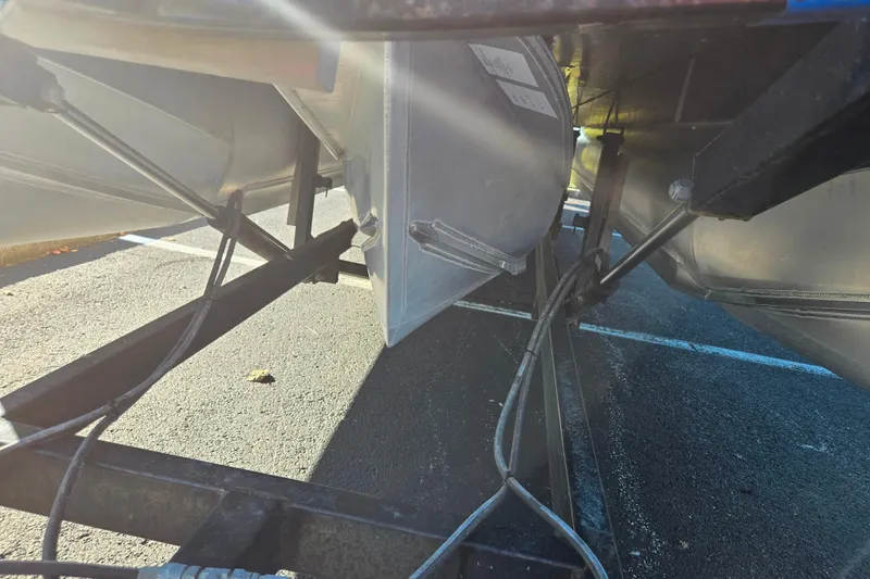 Slide: The Image of Underneath view of 2023 Avalon LSZ Quad Lounger pontoon boat on a trailer. - 7