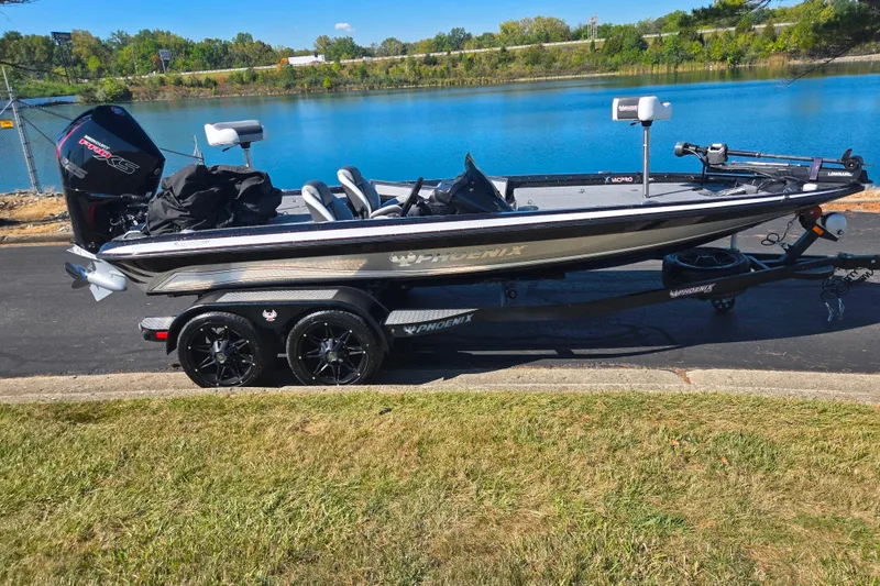 Slide: The Image of 2022 Phoenix 919 ProXP boat on trailer by a lake, sunny day. - 10