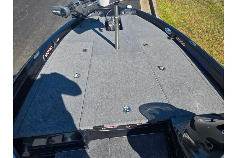 Slide: The Image of 2022 Phoenix 919 ProXP boat deck with carpeted surface and fishing equipment. - 12