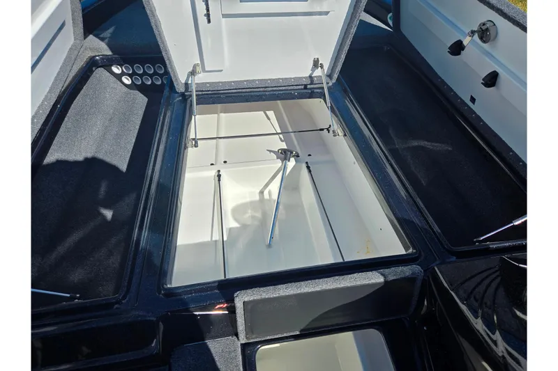Slide: The Image of 2022 Phoenix 919 ProXP boat storage compartment with open lid, showcasing interior space. - 13