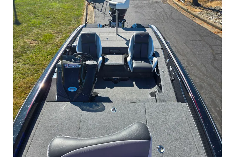 Slide: The Image of 2022 Phoenix 919 ProXP boat interior with dual seats and steering console. - 16
