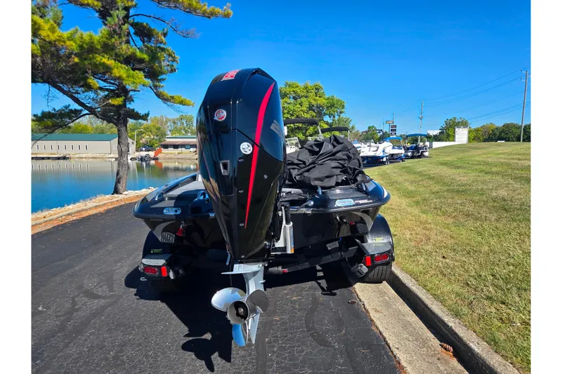 Slide: The Image of 2022 Phoenix 919 ProXP boat on trailer by a lakeside road. - 2