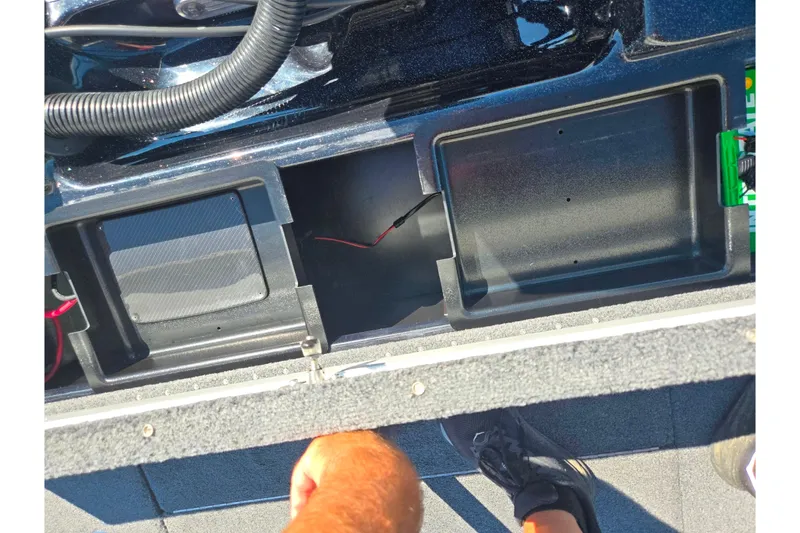 Slide: The Image of 2022 Phoenix 919 ProXP boat interior storage compartments with wiring visible. - 21