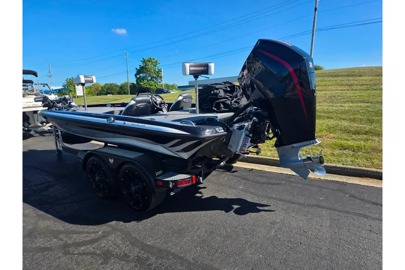 Slide: The Image of 2022 Phoenix 919 ProXP boat with powerful outboard motor, parked on a sunny day. - 3