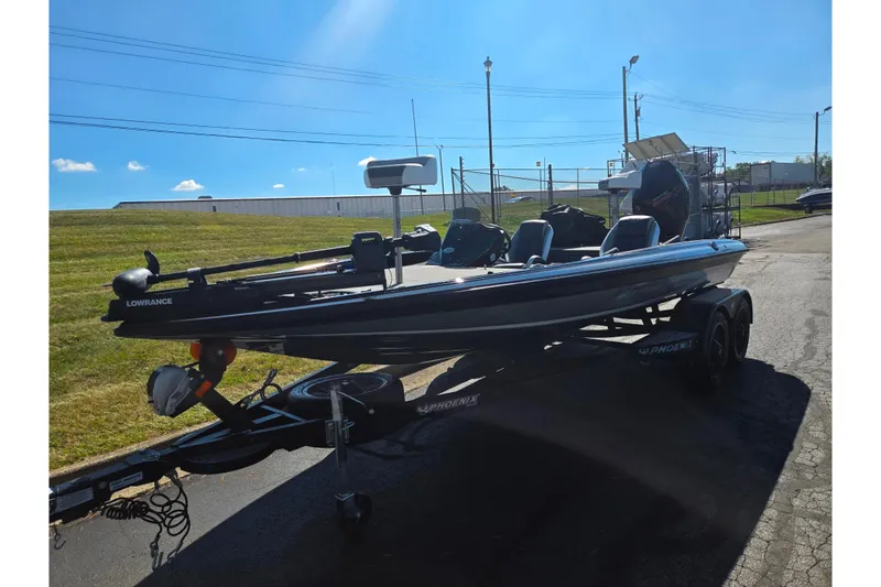 Slide: The Image of 2022 Phoenix 919 ProXP boat on trailer, equipped with Lowrance electronics, parked outdoors. - 6