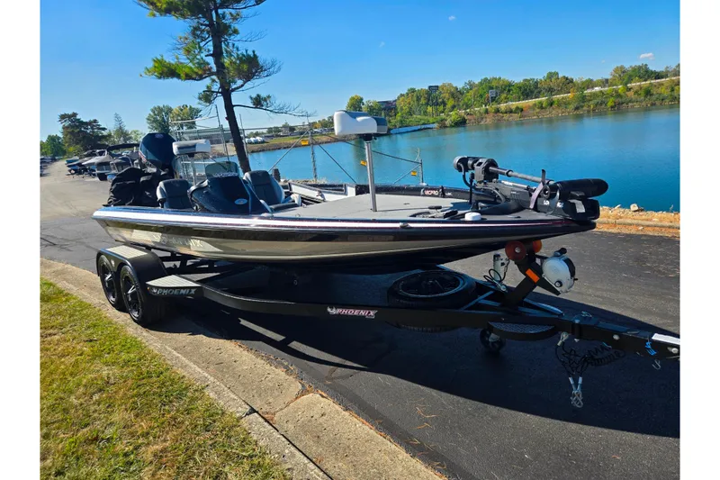 Slide: The Image of 2022 Phoenix 919 ProXP boat on trailer by a scenic lake. - 9