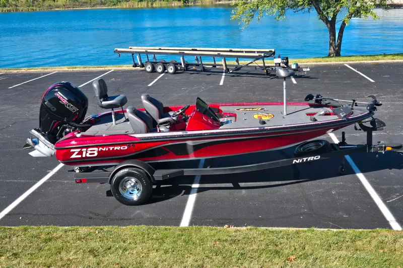 The Image of Red 2022 Nitro Z18 Pro boat parked near a lake with a trailer. - 0