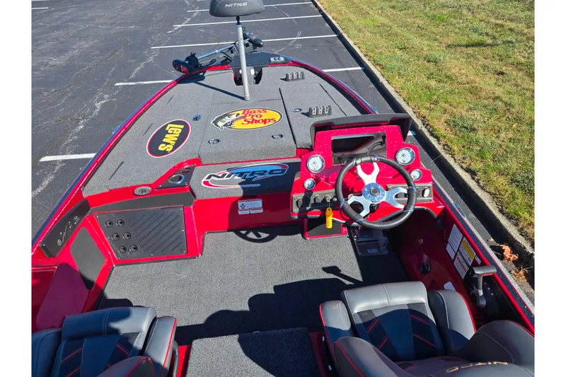 Slide: The Image of 2022 Nitro Z18 Pro boat interior with steering wheel and dashboard in parking lot. - 11