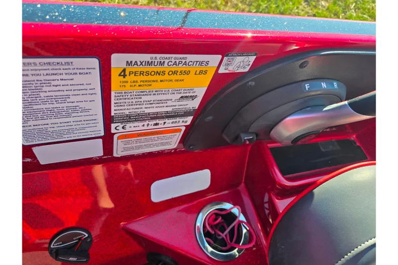 Slide: The Image of Red Nitro Z18 Pro 2022 boat dashboard with capacity and safety labels. - 13