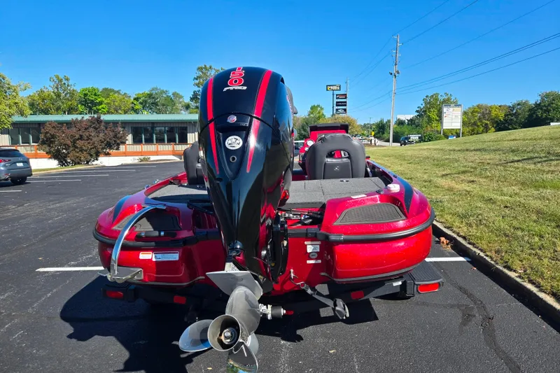 Slide: The Image of Red Nitro Z18 Pro 2022 boat with powerful outboard motor in parking lot. - 2