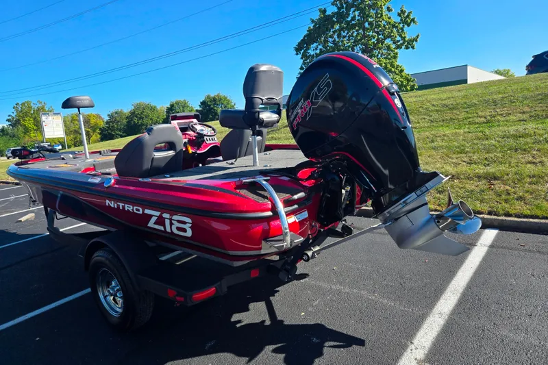 Slide: The Image of Red 2022 Nitro Z18 Pro boat with powerful outboard motor in a parking lot. - 3