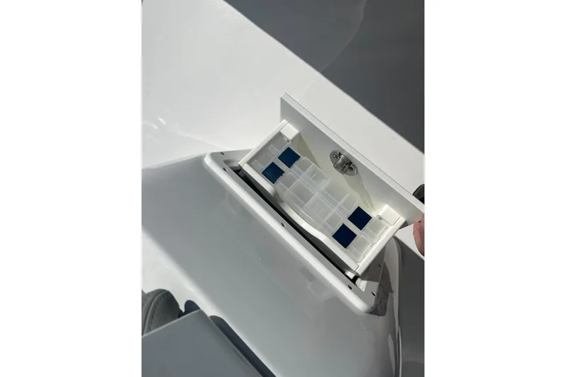 Slide: The Image of 2026 Cape Horn 27XS boat compartment with open lid, showcasing interior details. - 10