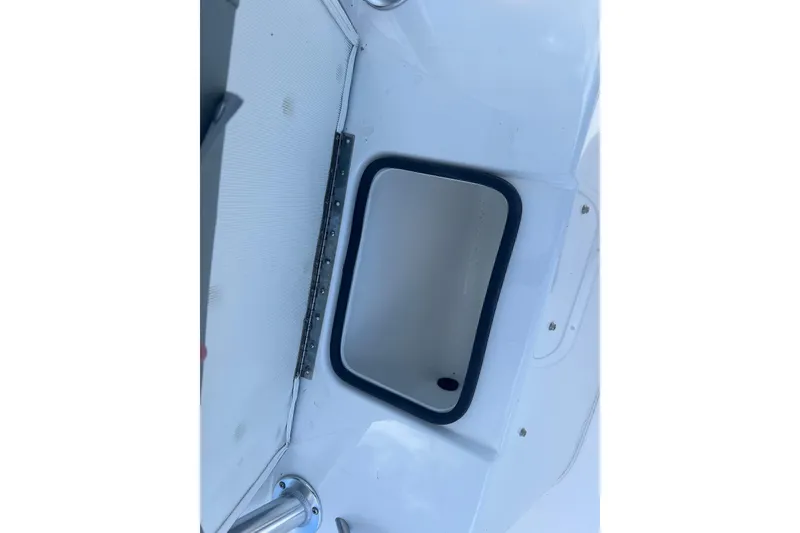 Slide: The Image of Open storage compartment on 2026 Cape Horn 27XS boat, featuring a white interior. - 11