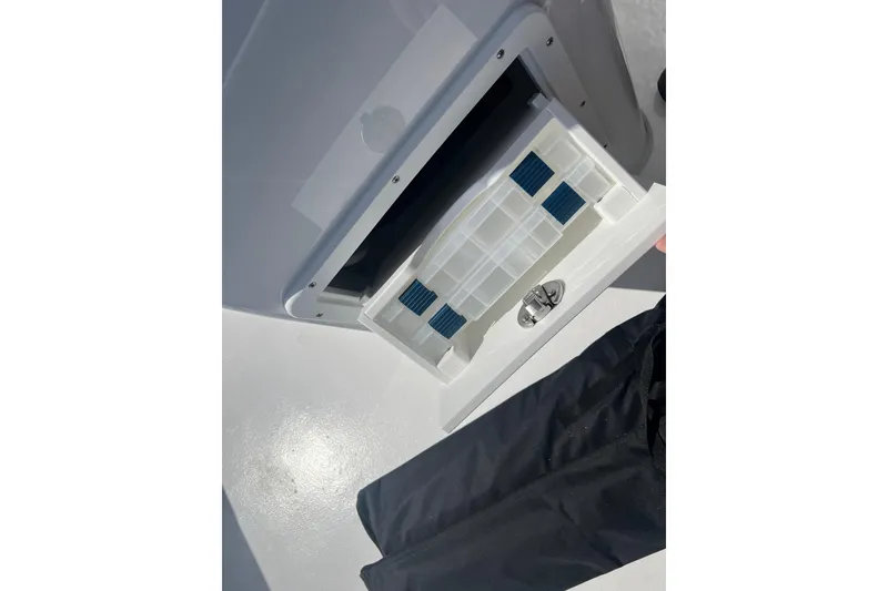 Slide: The Image of Open storage compartment on 2026 Cape Horn 27XS boat, featuring a secure latch mechanism. - 9