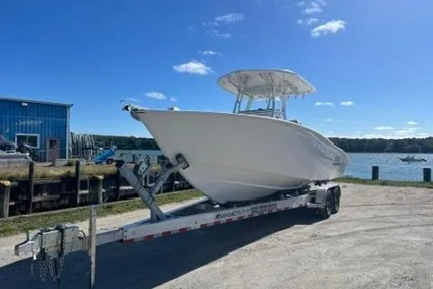 The Image of 2026 Cape Horn 27XS boat on trailer by waterfront under clear blue sky. - 0