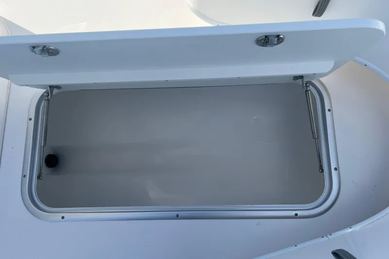 Slide: The Image of Open storage compartment on 2026 Cape Horn 27XS boat, showcasing interior space. - 12