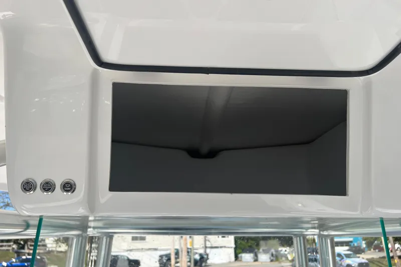 Slide: The Image of 2026 Cape Horn 27XS boat console with storage compartment and control buttons. - 15