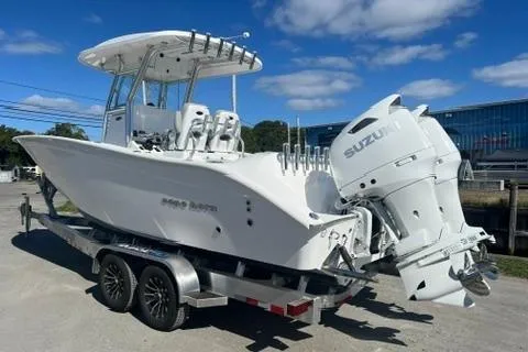 Slide: The Image of 2026 Cape Horn 27XS boat on trailer with dual Suzuki engines, under clear blue sky. - 3