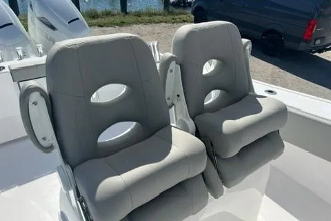 Slide: The Image of 2026 Cape Horn 27XS boat with dual cushioned seats, docked near water. - 5