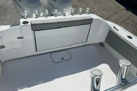 Slide: The Image of 2026 Cape Horn 27XS boat interior with rod holders and storage compartment. - 6