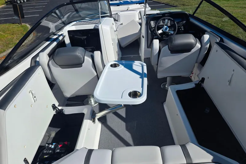 Slide: The Image of 2018 Yamaha Boats AR240 interior with seating, table, and steering wheel. - 10