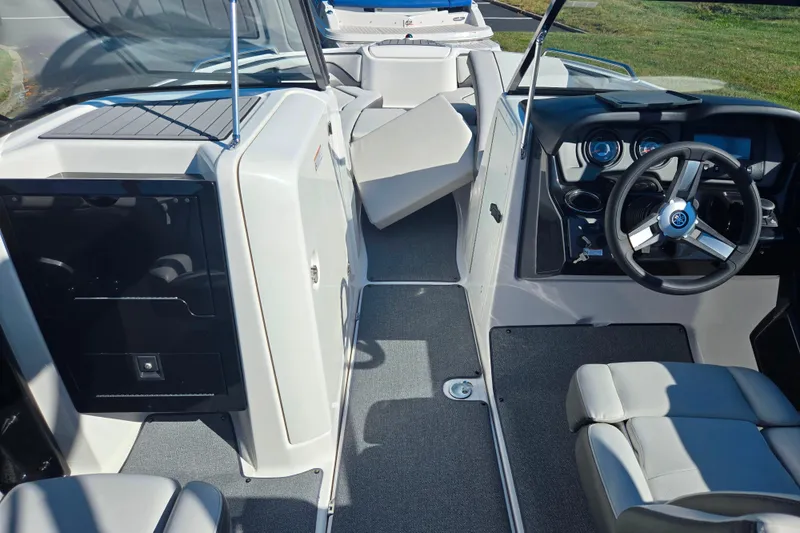Slide: The Image of 2018 Yamaha Boats AR240 interior with steering wheel and seating area. - 11