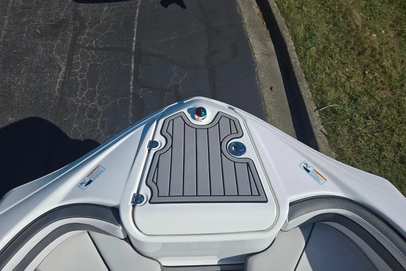 Slide: The Image of 2018 Yamaha Boats AR240 bow with sleek design and storage compartment. - 18