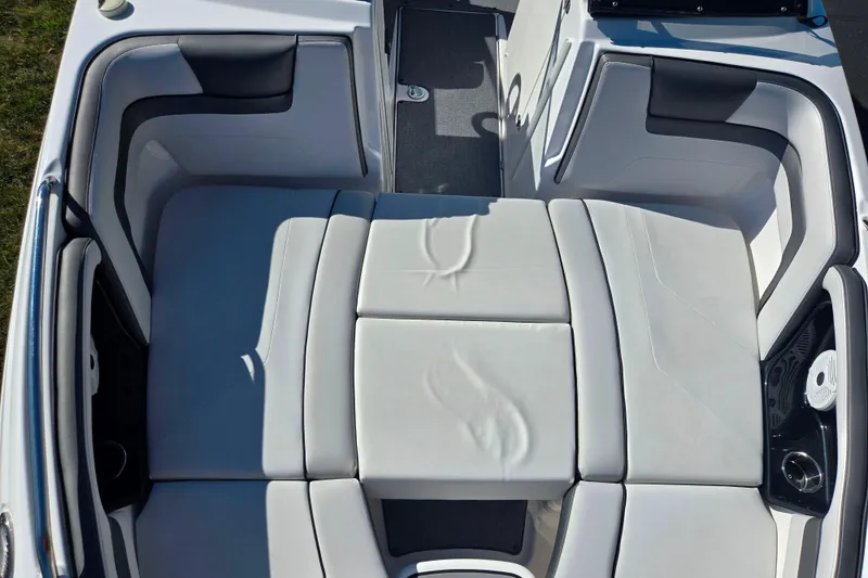 Slide: The Image of 2018 Yamaha Boats AR240 interior seating with white cushioned upholstery. - 19