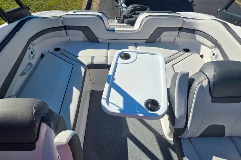 Slide: The Image of 2018 Yamaha Boats AR240 interior with seating and table, featuring cup holders. - 22