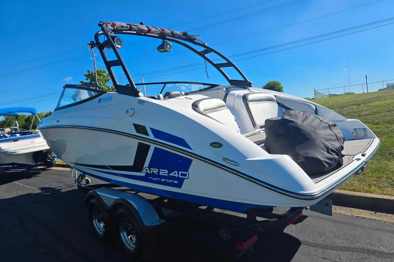 Slide: The Image of 2018 Yamaha Boats AR240 on trailer, sleek design, blue and white color scheme. - 3