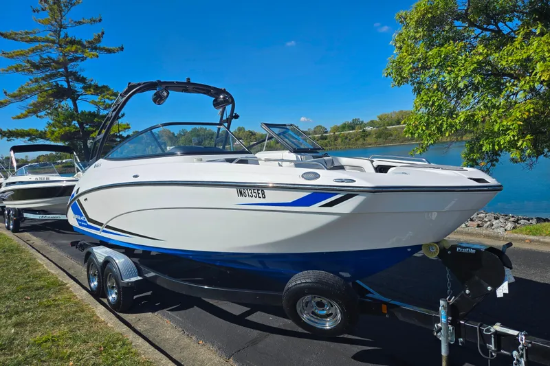 Slide: The Image of 2018 Yamaha Boats AR240 on trailer by a scenic lake, ready for adventure. - 8