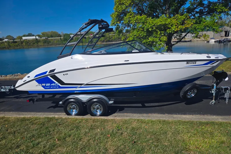Slide: The Image of 2018 Yamaha Boats AR240 on trailer by a lake, showcasing sleek design and vibrant colors. - 9