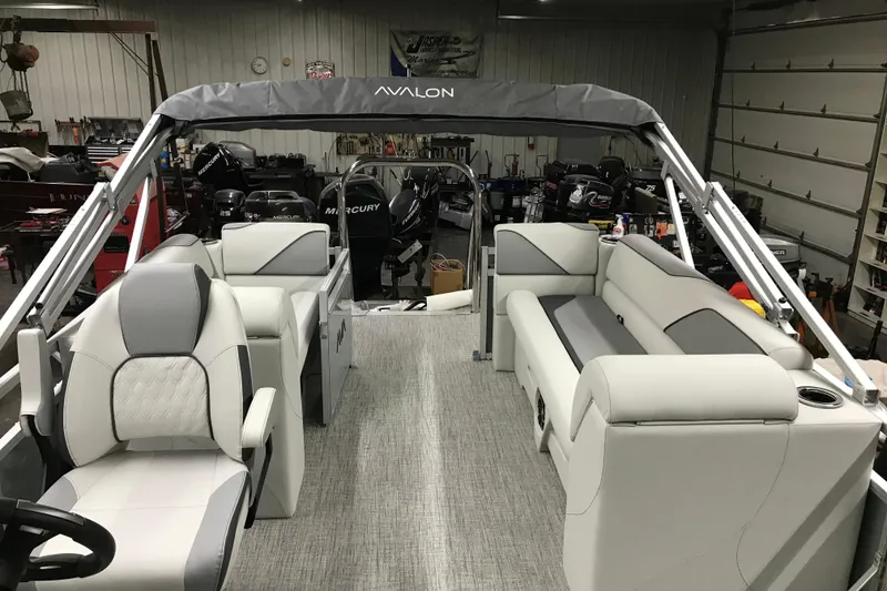 Slide: The Image of 2026 Avalon Venture Quad Lounger 19' pontoon boat interior with plush seating and modern design. - 16