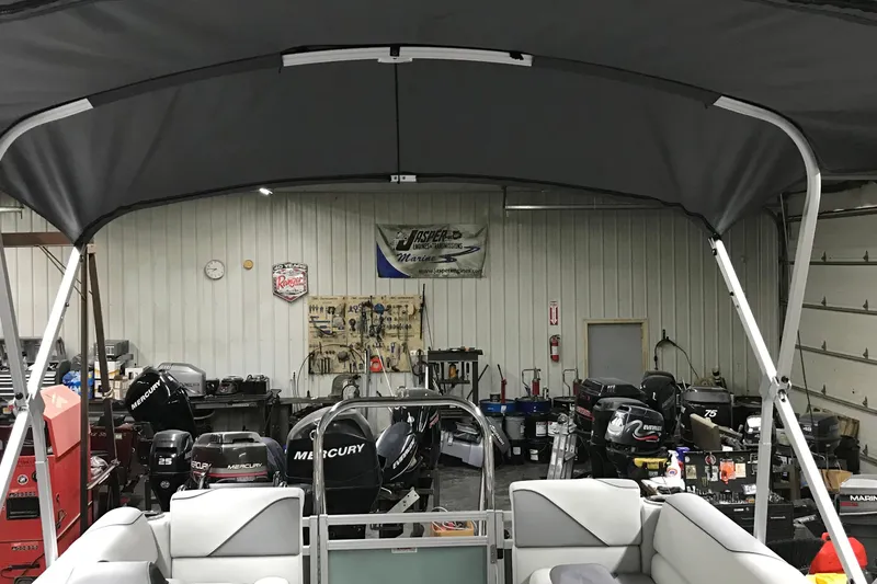 Slide: The Image of 2026 Avalon Venture Quad Lounger 19' in a workshop with Mercury engines. - 18