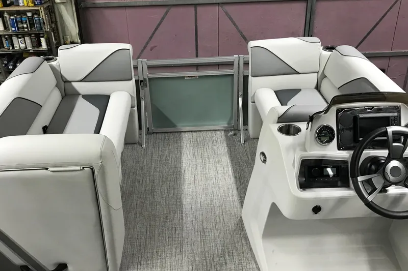 Slide: The Image of 2026 Avalon Venture Quad Lounger 19' interior with plush seating and modern helm controls. - 19