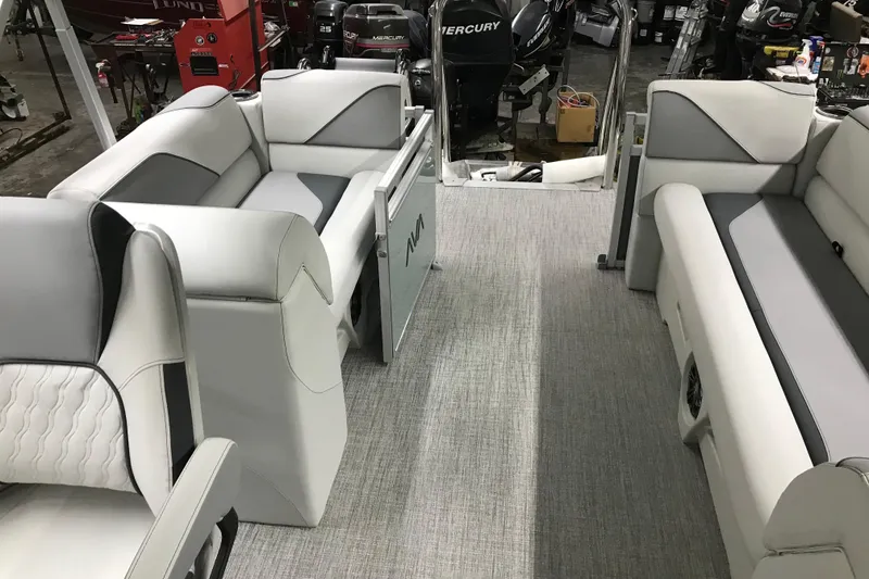 Slide: The Image of 2026 Avalon Venture Quad Lounger 19' interior with gray and white seating in a workshop. - 26