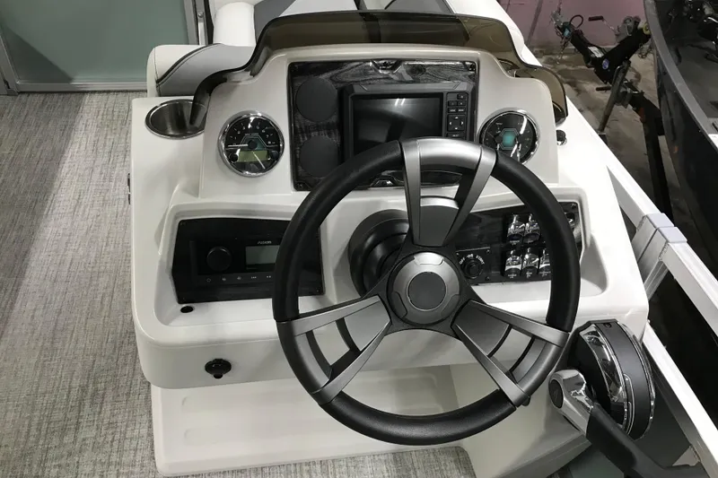Slide: The Image of Steering console of 2026 Avalon Venture Quad Lounger 19' with modern controls and gauges. - 30