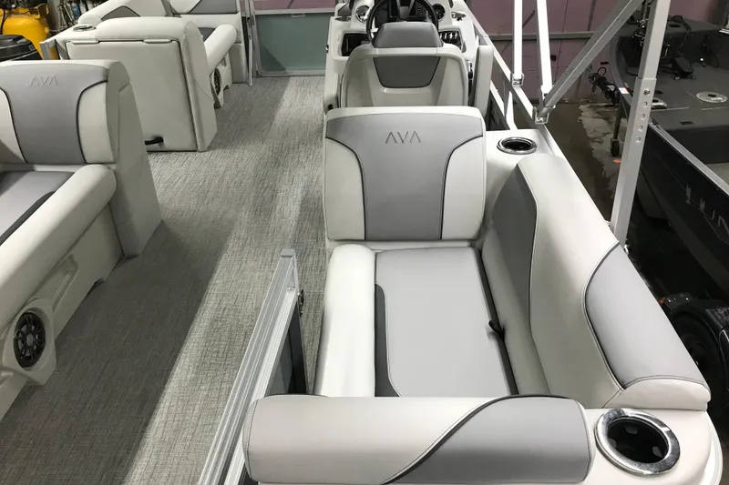 Slide: The Image of 2026 Avalon Venture Quad Lounger 19' interior with gray and white seating, cup holders, and modern design. - 32